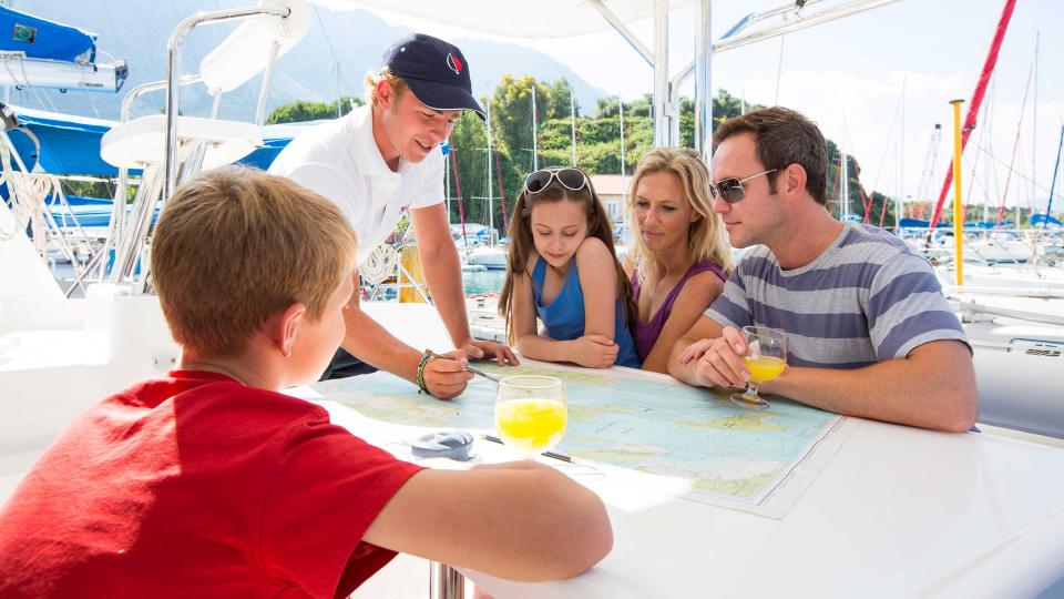 Skipper and family discussing sailing route