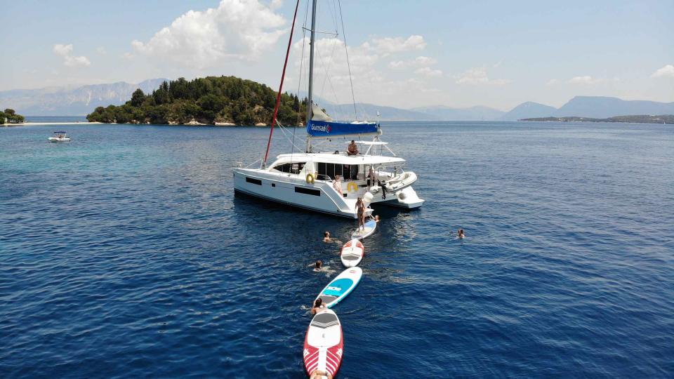 Sunsail catamaran with paddleboards