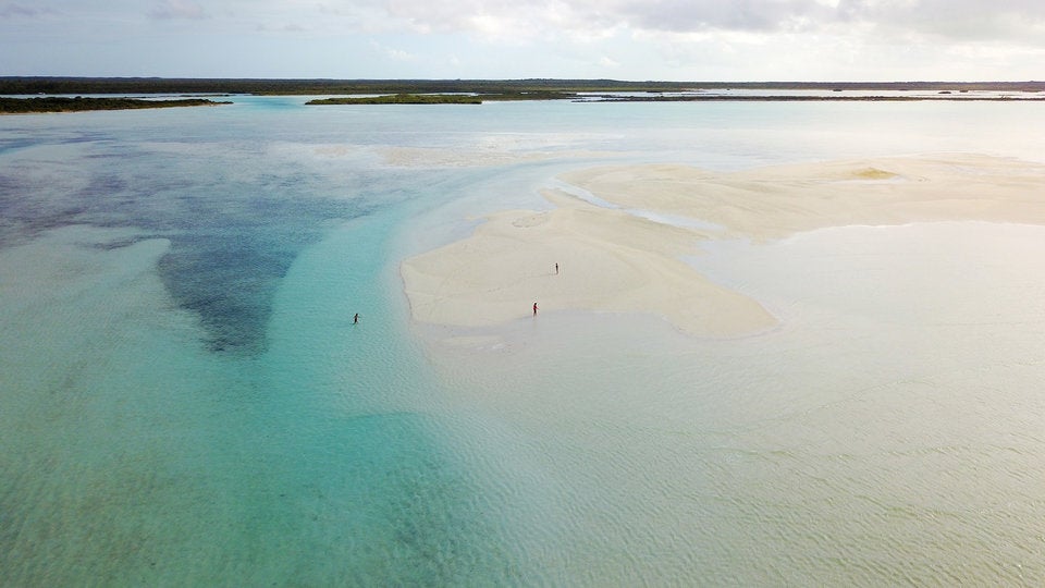 three people on deserted beaches