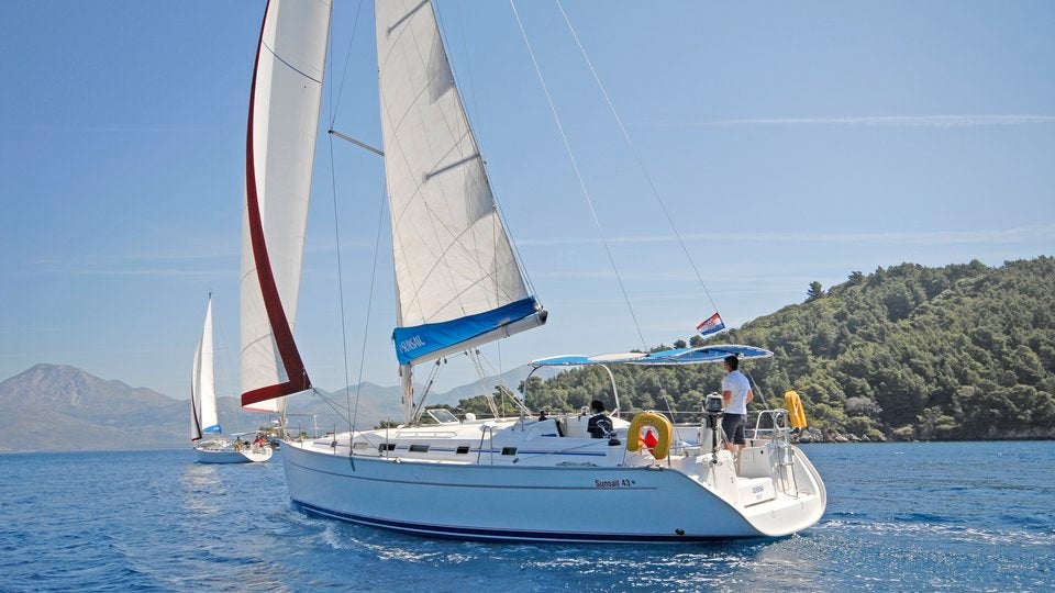 Sunsail yacht with view of Croatian coastline Sunsail yacht with view of Croatian coastline