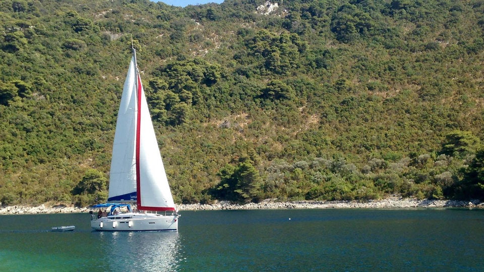 Sunsail yacht sailing into Okuklje Bay Sunsail yacht sailing into Okuklje Bay