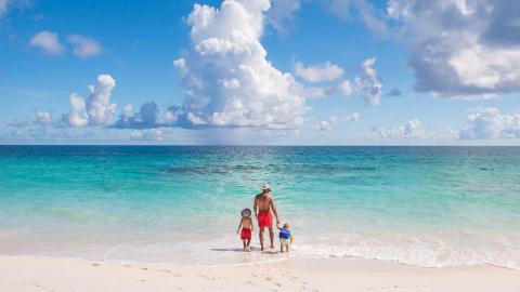 Father and sons walking on beach Father and sons walking on beach