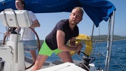 Skipper navigating yacht
